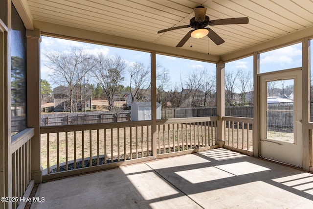 unfurnished sunroom with ceiling fan