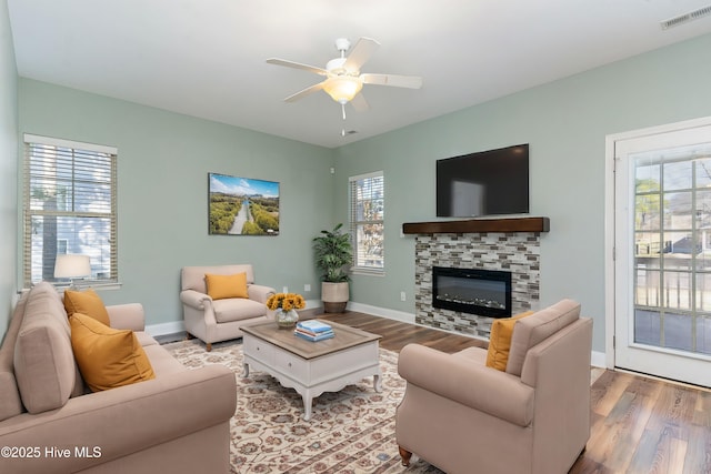 living room with hardwood / wood-style floors and ceiling fan