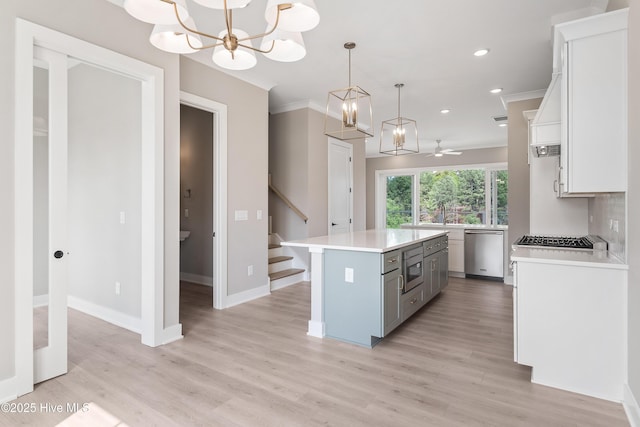 2660 Alvernia Dr, Castle Hayne, NC 28429 - kitchen with appliances with stainless steel finishes, light countertops, ornamental molding, gray cabinetry, and a center island