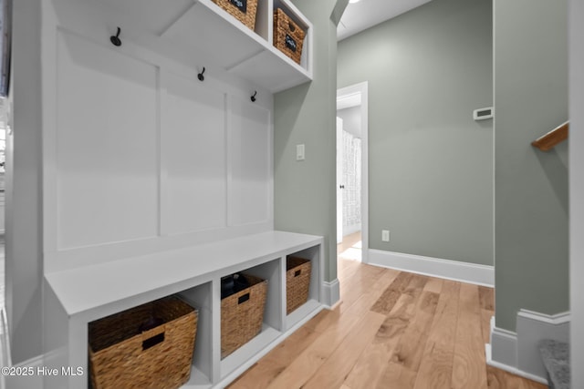 mudroom with light wood-style flooring and baseboards