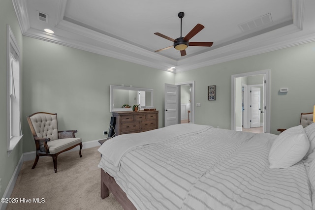 bedroom with baseboards, visible vents, a raised ceiling, light colored carpet, and ornamental molding