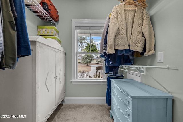 walk in closet featuring carpet