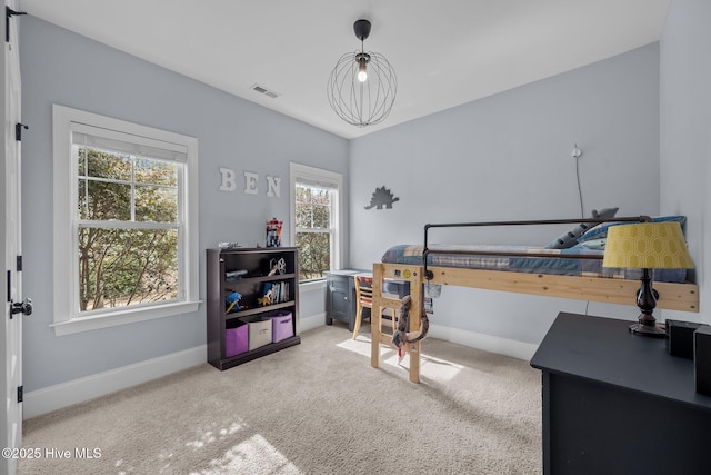 bedroom featuring light colored carpet, visible vents, and baseboards