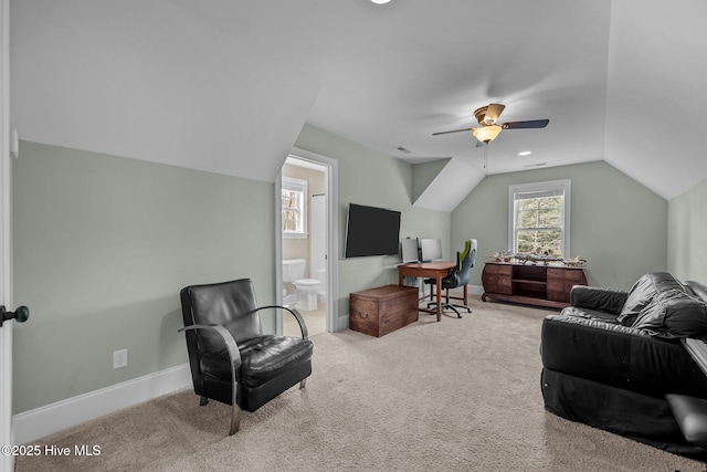 office featuring visible vents, baseboards, a ceiling fan, vaulted ceiling, and carpet flooring