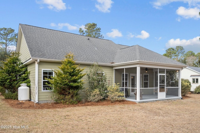 rear view of property featuring a shingled roof, a sunroom, and ceiling fan