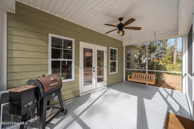 sunroom / solarium with wooden ceiling and a ceiling fan