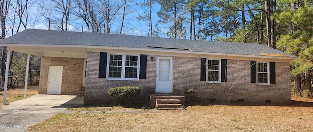 view of front facade featuring crawl space, a front yard, concrete driveway, and brick siding