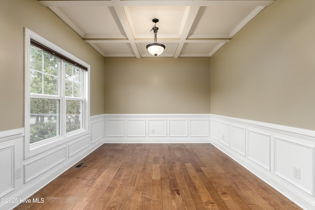 unfurnished room featuring hardwood / wood-style flooring, coffered ceiling, and beamed ceiling