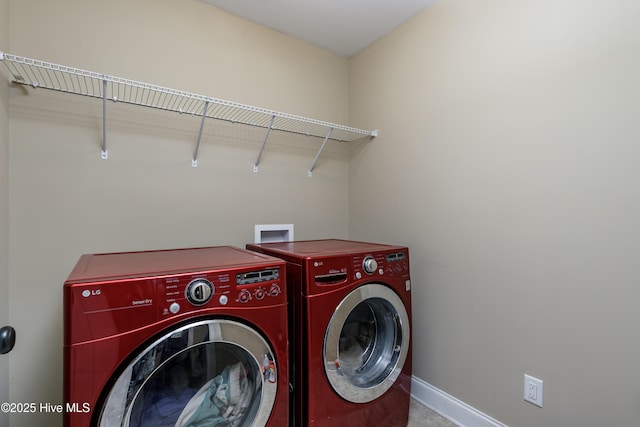 clothes washing area featuring washer and clothes dryer