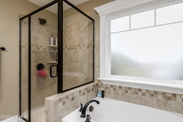 bathroom with shower with separate bathtub