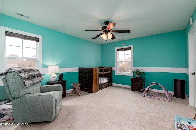 sitting room with carpet and ceiling fan