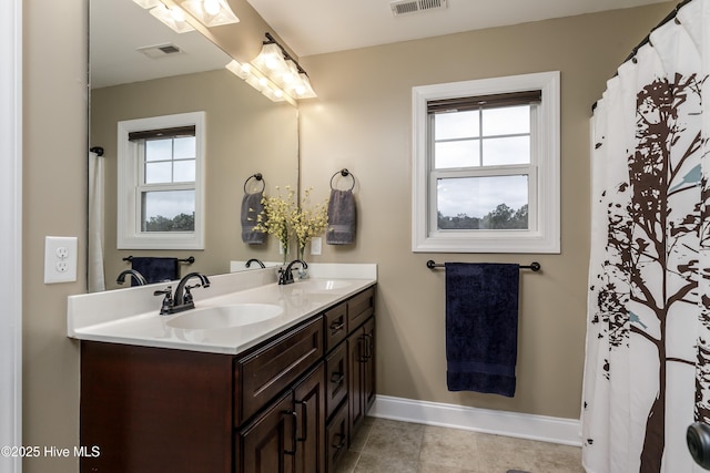 bathroom featuring vanity, tile patterned flooring, and a wealth of natural light