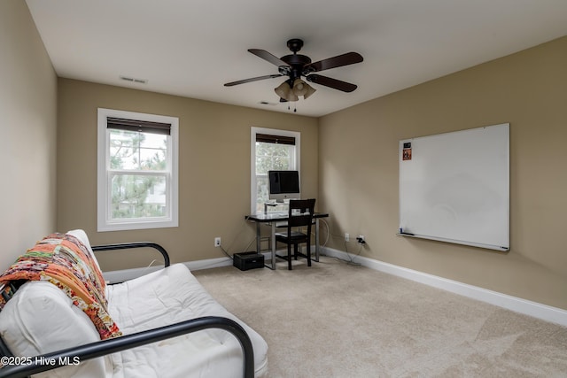 carpeted office with ceiling fan