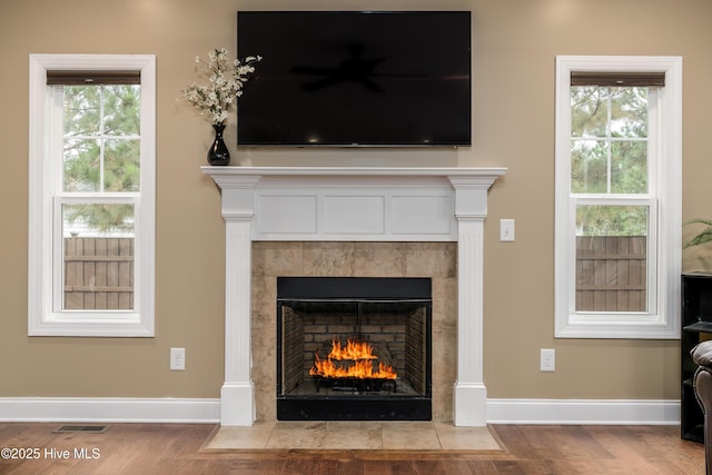 interior details featuring wood-type flooring and a fireplace