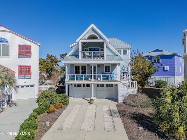 view of front of property featuring a garage, a balcony, and covered porch