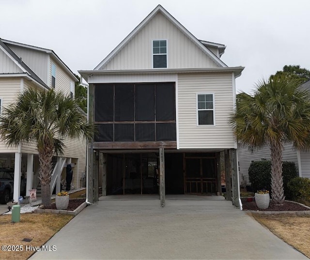 view of front of house featuring a sunroom and a carport