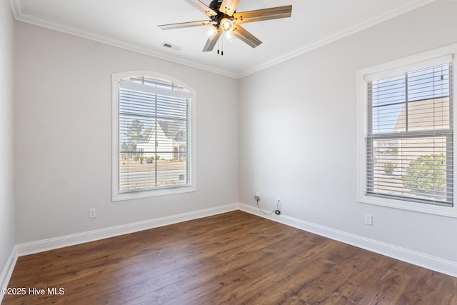 spare room featuring dark wood-type flooring, ceiling fan, and ornamental molding