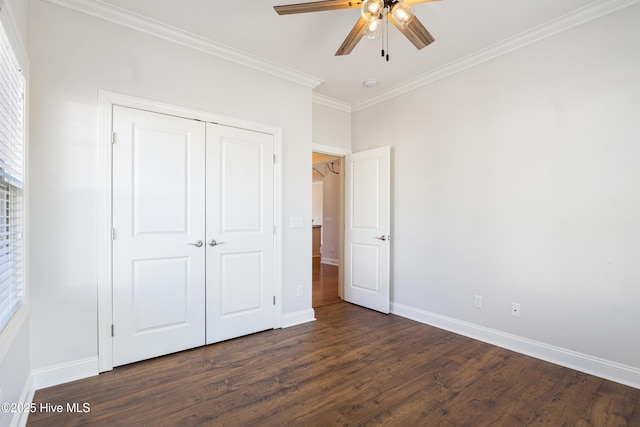 unfurnished bedroom with crown molding, ceiling fan, dark hardwood / wood-style flooring, and a closet