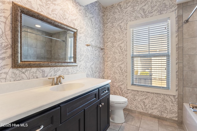 full bathroom featuring vanity, tiled shower / bath, tile patterned floors, and toilet