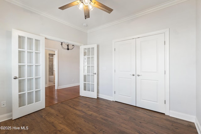 unfurnished bedroom with dark hardwood / wood-style floors, french doors, ornamental molding, ceiling fan, and a closet