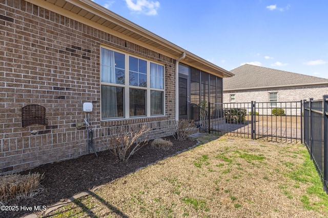 view of side of property featuring a yard and a sunroom