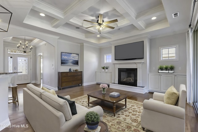 living room featuring beamed ceiling, coffered ceiling, and hardwood / wood-style flooring