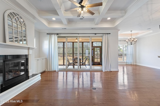 unfurnished living room featuring dark wood-type flooring, coffered ceiling, ceiling fan with notable chandelier, and beamed ceiling