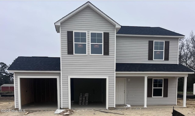 view of front property featuring a garage and a porch