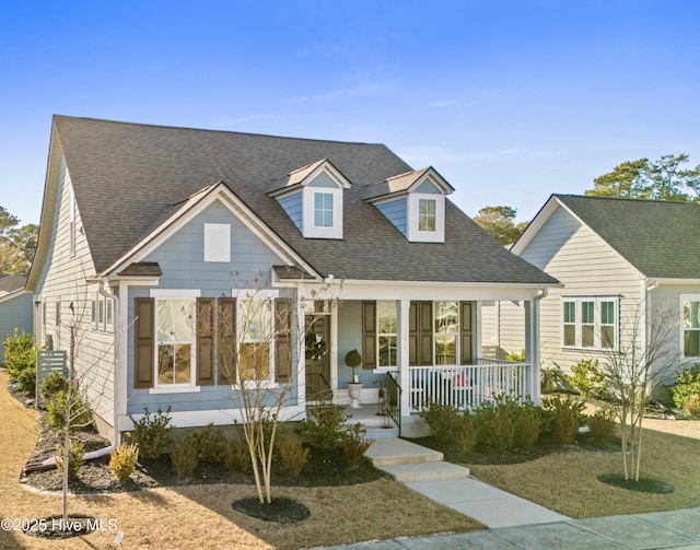 cape cod-style house featuring a porch