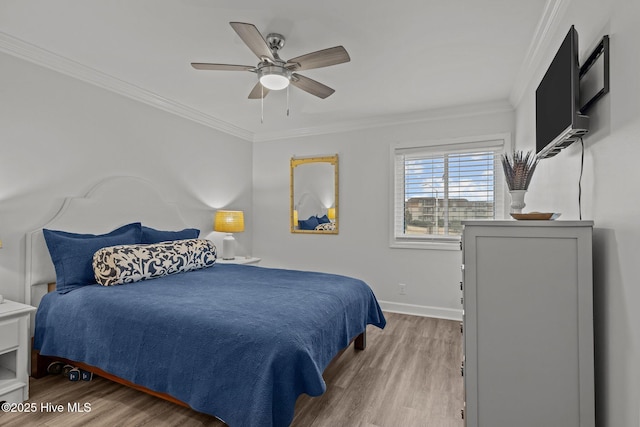 bedroom with ornamental molding, wood finished floors, a ceiling fan, and baseboards