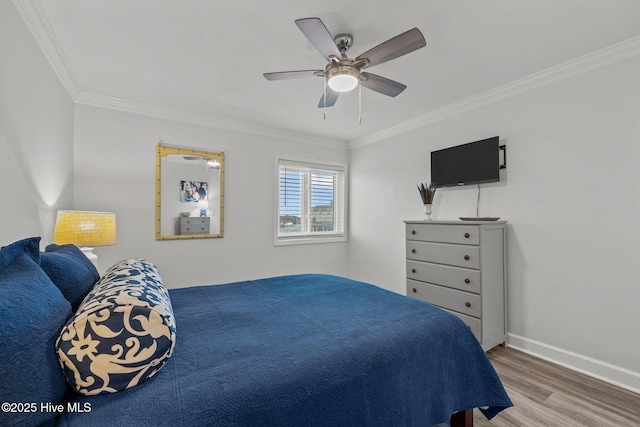 bedroom with ornamental molding, ceiling fan, baseboards, and wood finished floors