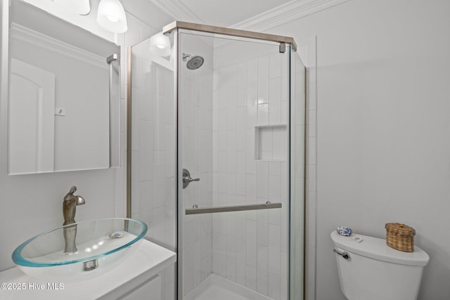 bathroom with crown molding, a shower stall, toilet, and vanity