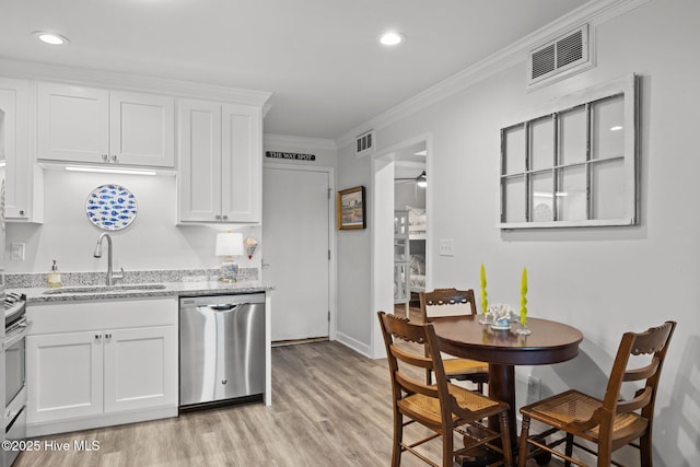 kitchen featuring crown molding, visible vents, dishwasher, and a sink