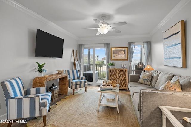 living room featuring wood finished floors, a ceiling fan, and crown molding