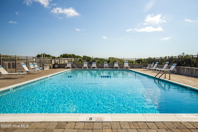 pool featuring a patio area and fence