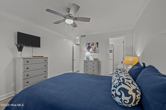 bedroom featuring visible vents, crown molding, baseboards, and wood finished floors