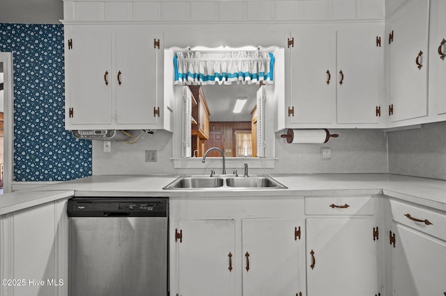 kitchen with sink, white cabinets, and dishwasher