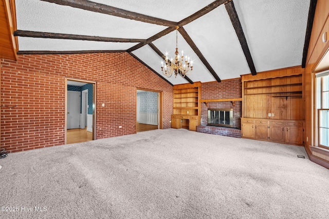 unfurnished living room featuring lofted ceiling with beams, a textured ceiling, built in features, light colored carpet, and a fireplace