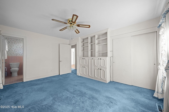 unfurnished bedroom with ceiling fan, connected bathroom, carpet flooring, and a closet