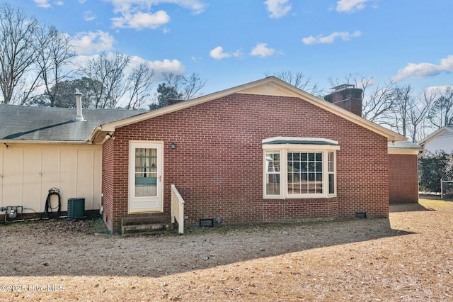 rear view of property featuring central AC unit