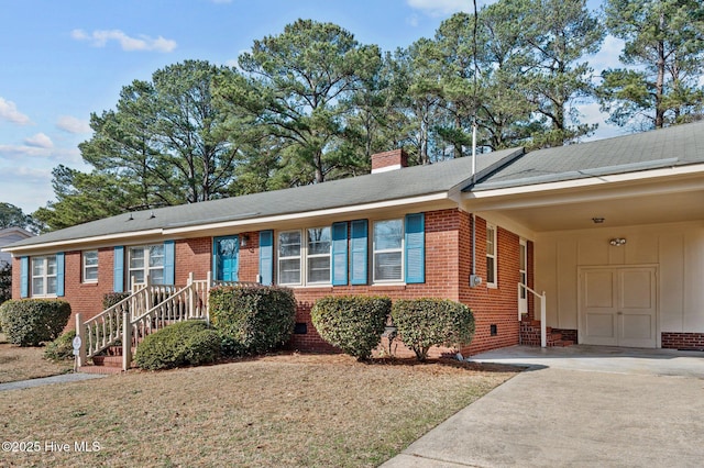 ranch-style house featuring a carport and a front lawn