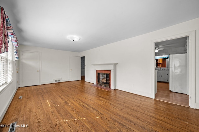 unfurnished living room featuring hardwood / wood-style flooring