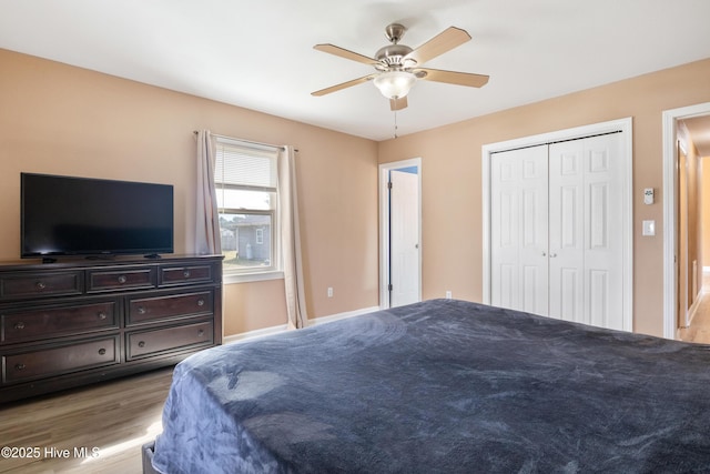 bedroom featuring a closet, ceiling fan, and light hardwood / wood-style flooring