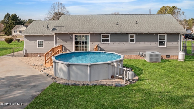 view of pool featuring central AC and a lawn