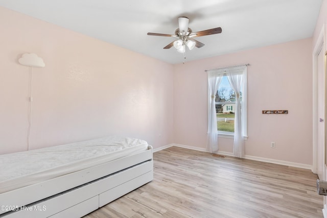 unfurnished bedroom with ceiling fan and light hardwood / wood-style floors