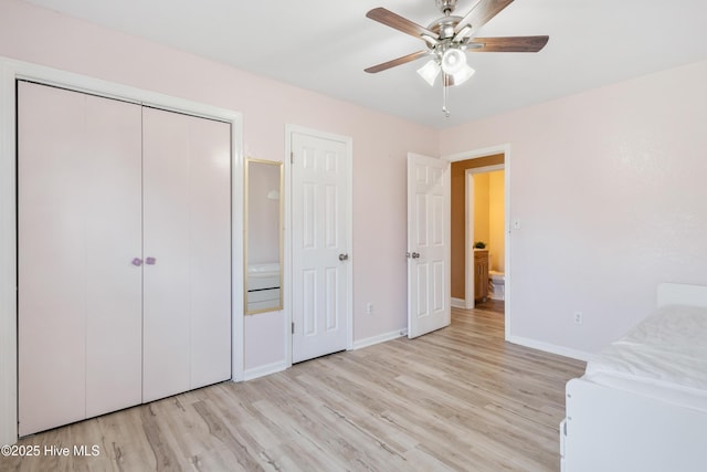 unfurnished bedroom with ceiling fan, light wood-type flooring, and a closet