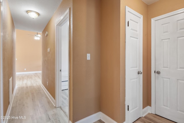 hallway with light wood-type flooring