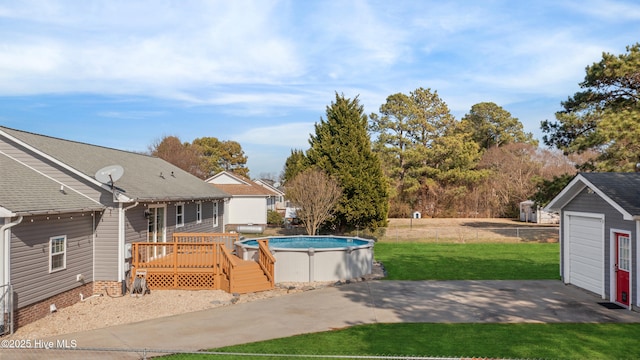 view of swimming pool featuring a wooden deck and a lawn