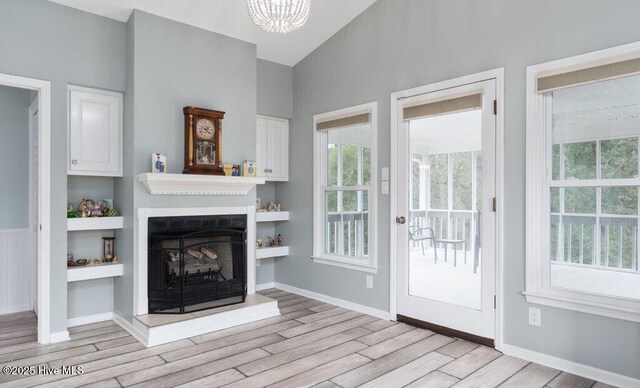 unfurnished dining area with crown molding, dark wood-style flooring, and wainscoting