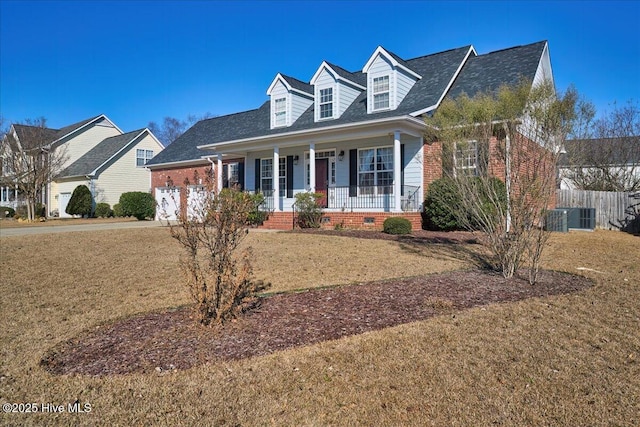 new england style home with a garage, central AC, a front lawn, and covered porch